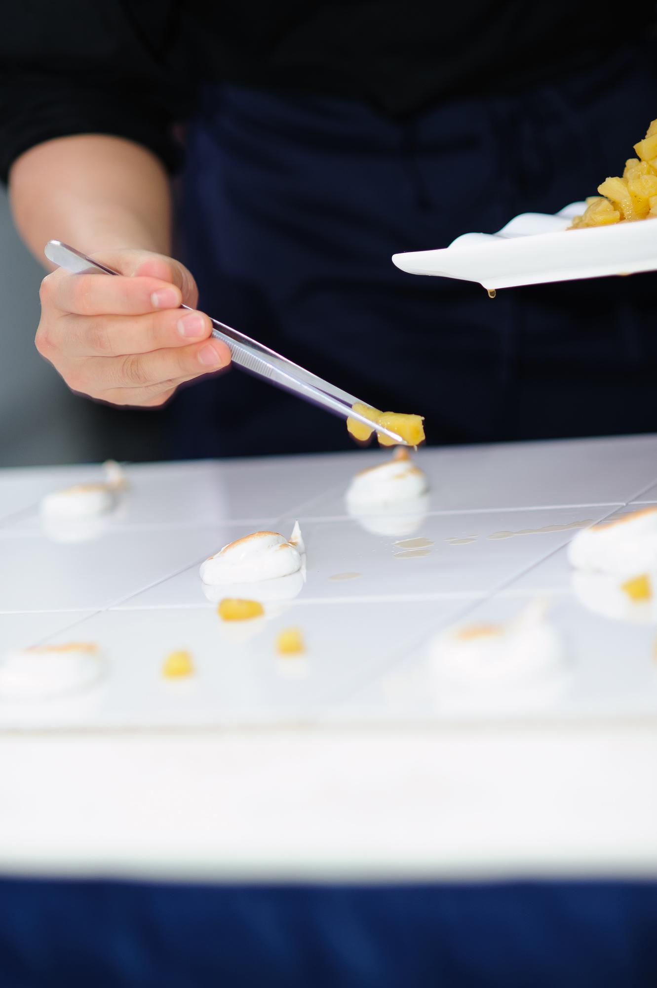 Large shot of chef plating a modern dish